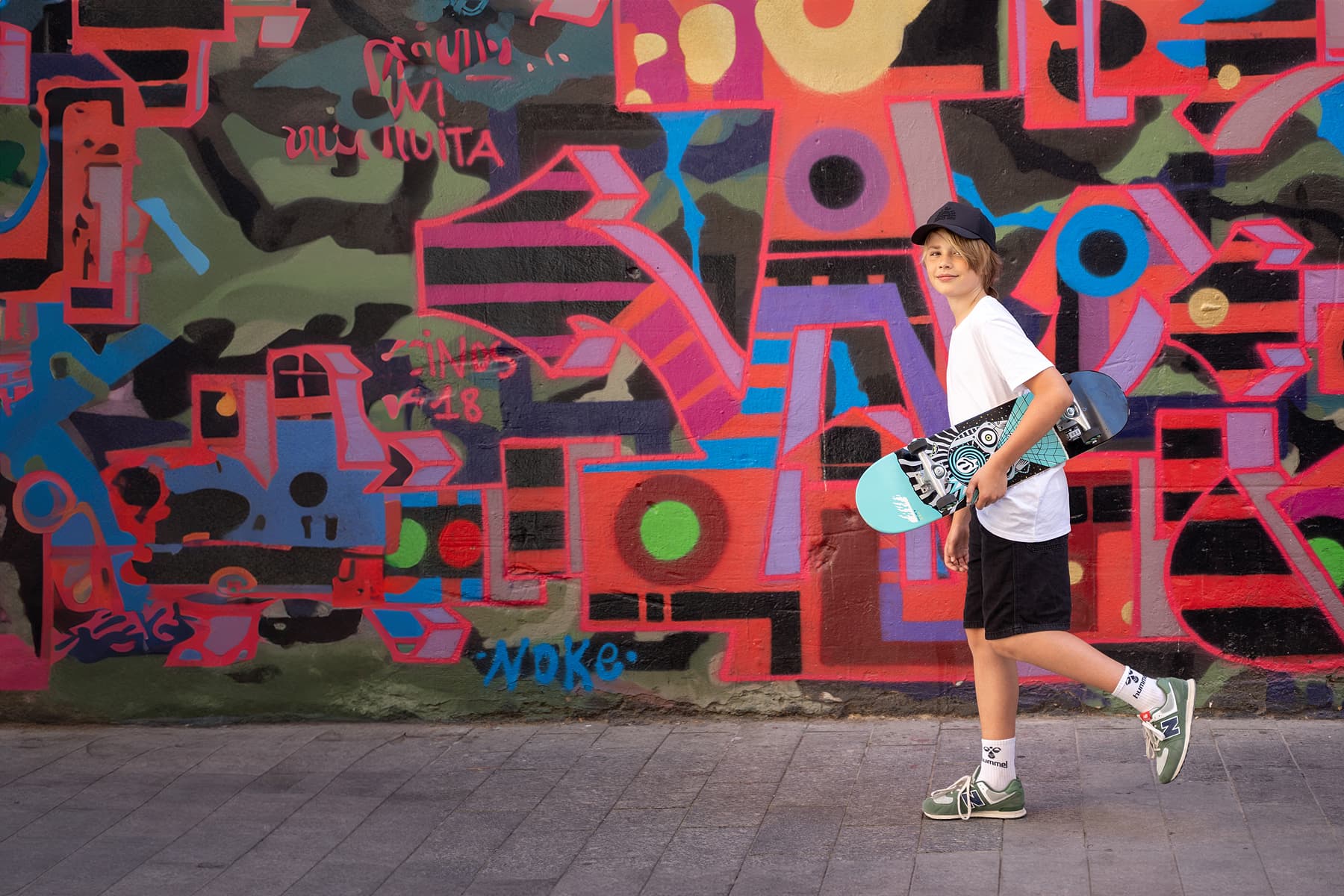 Professional model test featuring a teenager sport fashion model in natural light with skateboard