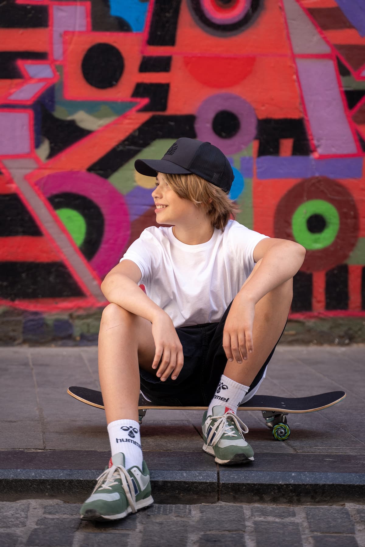 Professional model test featuring a teenager sport fashion model in natural light with skateboard