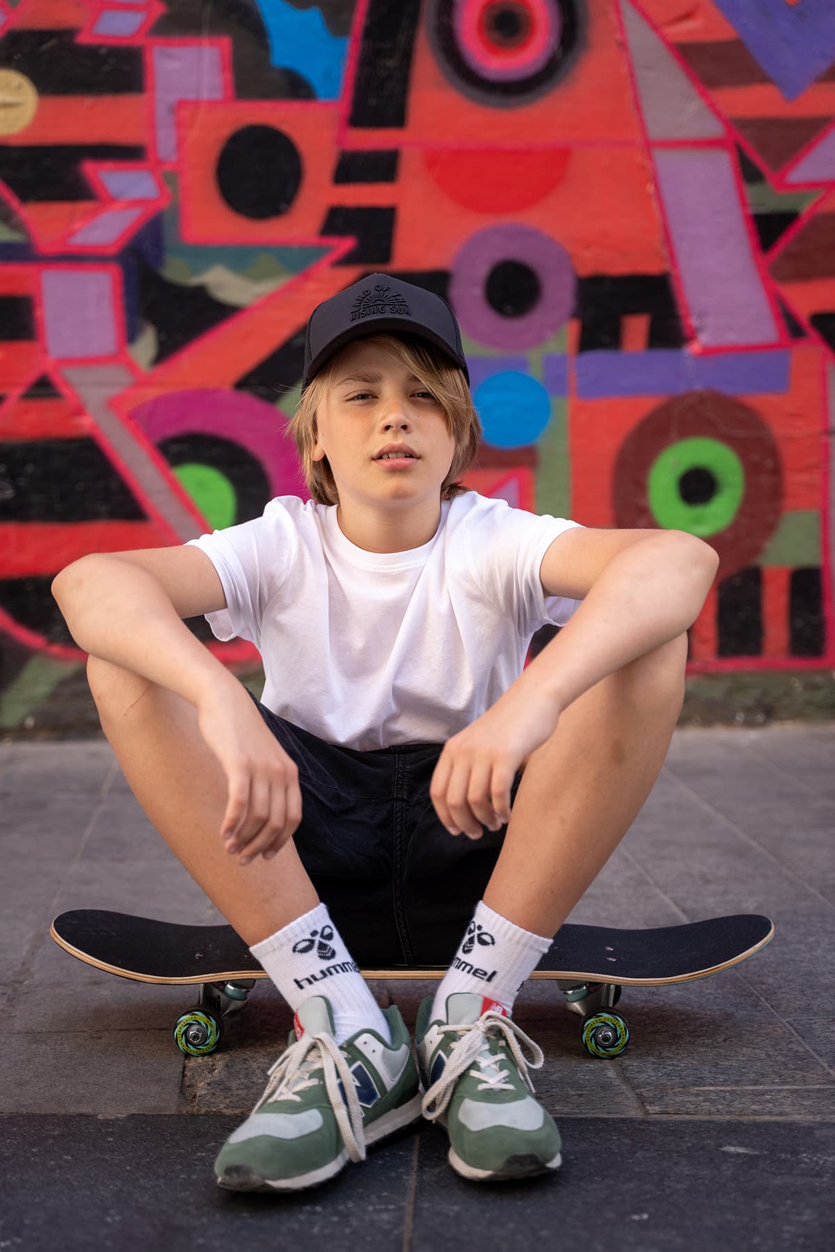 Professional model test featuring a teenager sport fashion model in natural light with skateboard