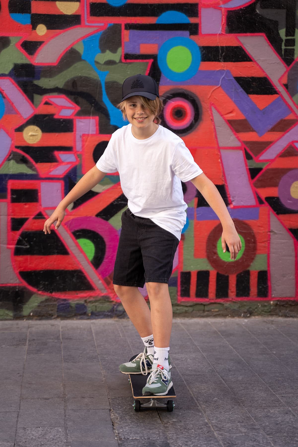 Professional model test featuring a teenager sport fashion model in natural light with skateboard