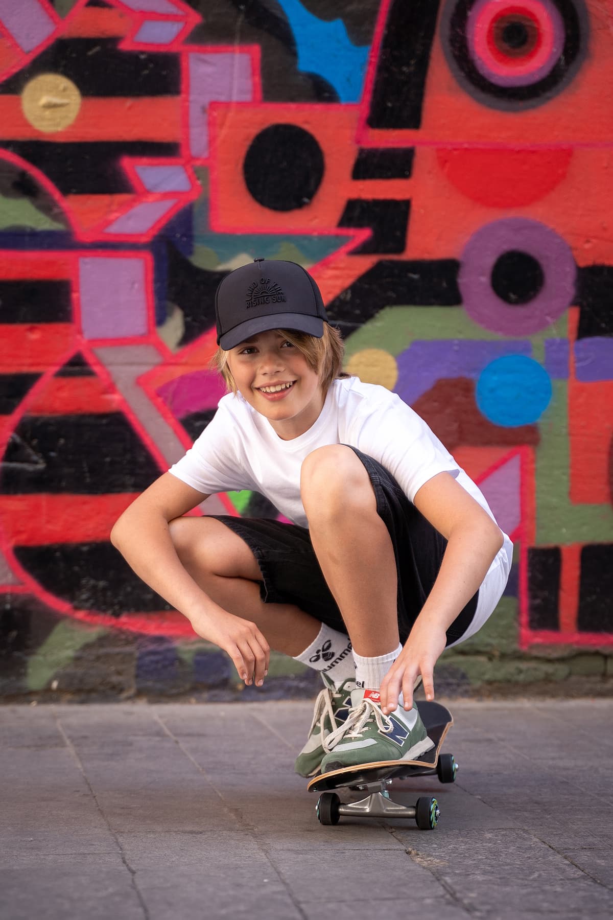 Professional model test featuring a teenager sport fashion model in natural light with skateboard