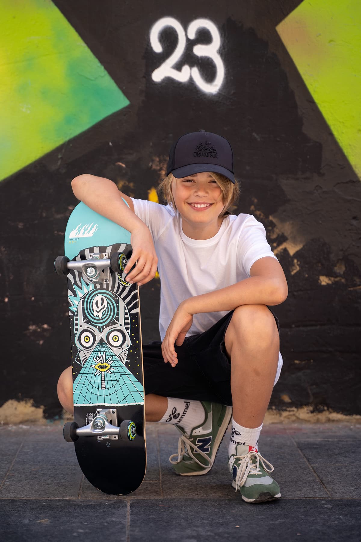 Professional model test featuring a teenager sport fashion model in natural light with skateboard