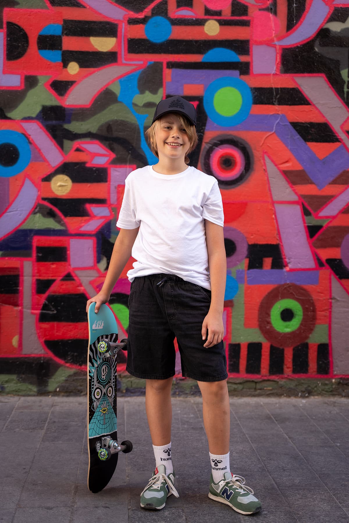 Professional model test featuring a teenager sport fashion model in natural light with skateboard
